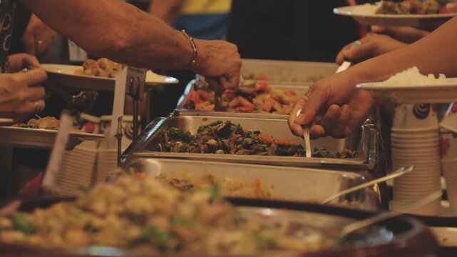scooping the food, buffet food at restaurant, catering