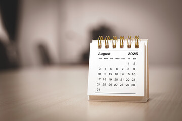 Calendar page August of the year 2025 white color in meeting room in office. with copy space and business design. concept of planning and setting new strategic goals.