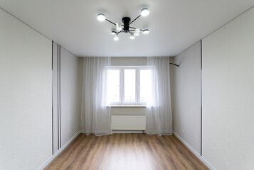 There is a chandelier in the ceiling of the room