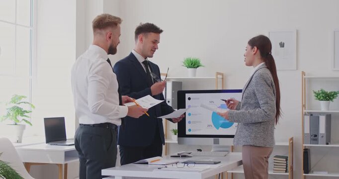 Female ceo, business analyst training diverse corporate office staff during briefing group meeting at desk in modern boardroom holding stats data thinking together on financial statement analysis
