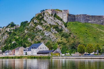 Charlemont fortress on the hill against blue sky in the background, cityscape of Givet city,...