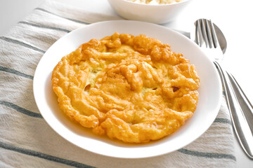 Thai omelette on a white plate.