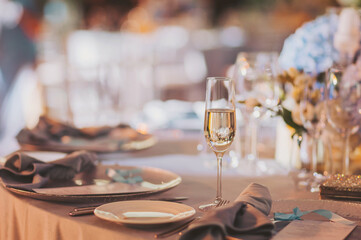 Champagne glass on a restaurant table. Champagne and wedding. 