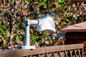 Personal weather station mounted on a wooden fence in a garden. It is a useful tool for monitoring...