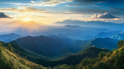 Obraz premium A breathtaking panorama of layered mountains bathed in golden sunlight, casting long shadows across the lush greenery.