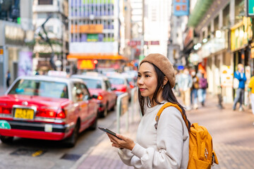 Young woman traveler walking in the Mong Kok in Hong Kong, Mong Kok is one of the major shopping...