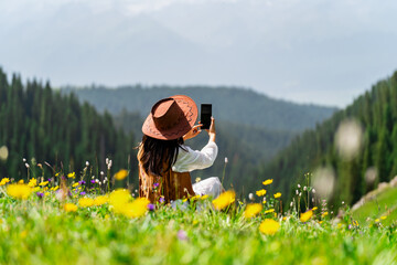 Young woman traveler relaxing and enjoying beautiful Scenery landscape with colorful flowers in Kalajun grassland of Xinjiang in summer