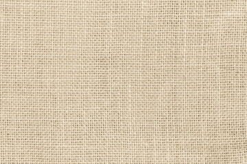 Closeup detail of beige fabric texture background. High resolution photo.
