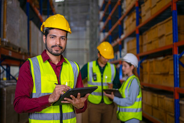 Blue collar workers are working at warehouse.