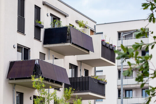 Balcony Solar Panels for Strata Apartment Buildings. Mini Solar Power Station on Balconies of Modern Apartment Bilding in Germany.