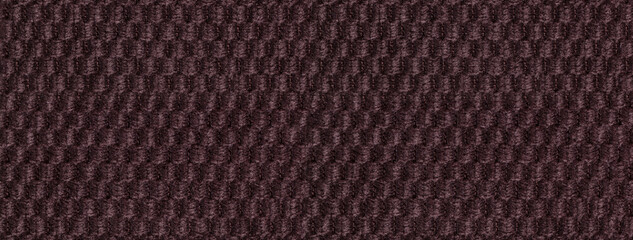Texture dark brown fluffy fabric background with rhomboid pattern, macro. Abstract backdrop from umber textile