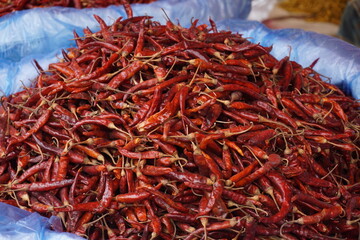 A heap of dry red chili pepper is displayed in a spice market, Dried spicy red chilies are on sale, Showcase of spicy red chili in a spice shop in Asia for the spice trade