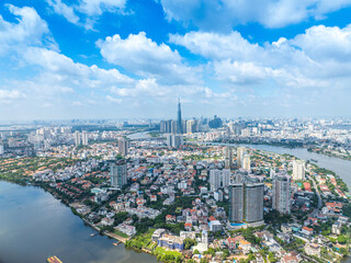 Fototapeta premium Panoramic view of Saigon, Vietnam from above at Ho Chi Minh City's central business district. Cityscape with Landmark 81 skyscraper and many buildings, local houses, rivers.
