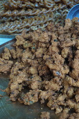 Mix vegetable pakora making and being displayed by a street food vendor, Crispy onion and potato pakoda selling on a market, Spicy veg pakora or pakoda displayed on a rural fair for sale