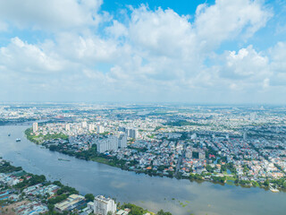 Panoramic view of Saigon, Vietnam from above at Ho Chi Minh City's central business district. Cityscape and many buildings, local houses, bridges, rivers.