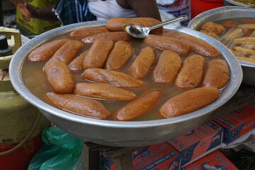 Popular Bangladeshi dessert Gulab Jamun with sugar syrup, Traditional Bangladeshi sweet called rasgulla or rasgoola is being sold at a market, Gulab jamun and rasgulla are displayed together