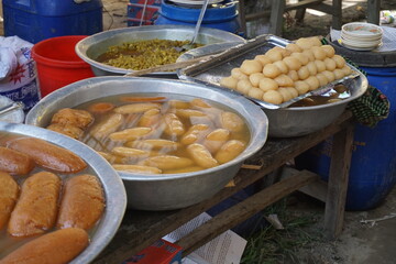 Popular Bangladeshi dessert Gulab Jamun with sugar syrup, Traditional Bangladeshi sweet called rasgulla or rasgoola is being sold at a market, Gulab jamun and rasgulla are displayed together