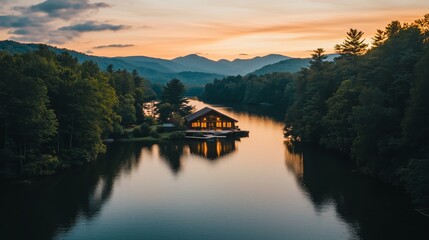 Fototapeta premium A cabin is on a lake surrounded by trees. The cabin is wooden and has a porch. The lake is calm and peaceful.