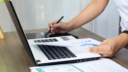 Fototapeta premium Businesswoman is analyzing financial data and marketing growth report graph. Business planning, investment and marketing ideas