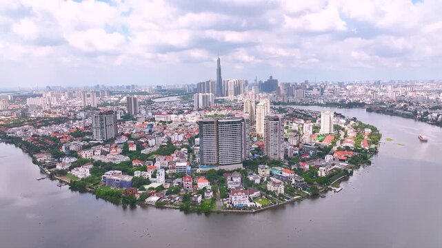 Panoramic view of Saigon, Vietnam from above at Ho Chi Minh City's central business district. Cityscape with Landmark 81 skyscraper and many buildings, local houses, rivers.