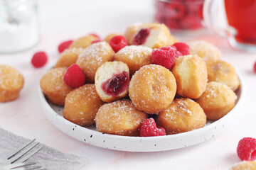 A plate wit traditional berliner cakes with jelly