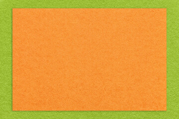 Fototapeta premium Texture of craft orange color paper background with green border, macro. Vintage kraft ginger cardboard
