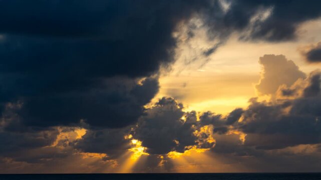 Timelapse. Big bright Yellow sun down behide big cloud . Awesome landscape of sky and silhouette