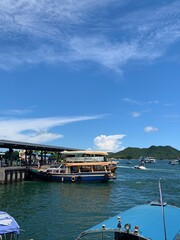 scenic view of a harbour with boats docked and a clear blue sky in the background.