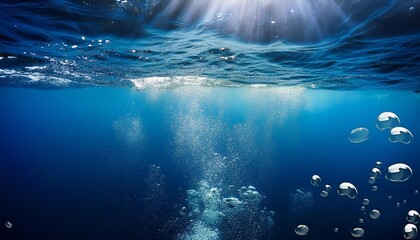 Obraz premium Underwater view with bubbles rising to the surface in a deep blue ocean. The image captures the serenity and mystery of the underwater world