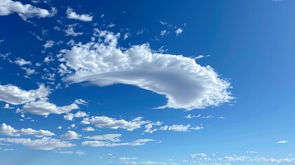 A bright blue sky with white fluffy clouds.