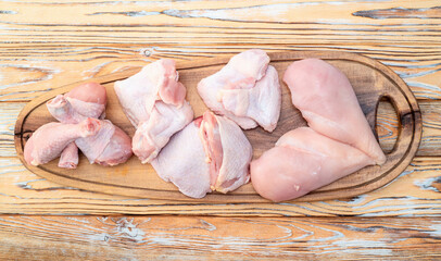 Raw mixed chicken meat parts  for cooking on rustic background