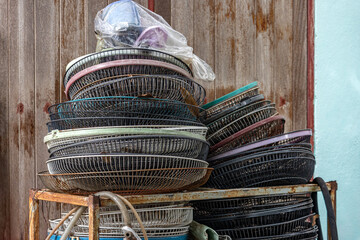 Protective fan grilles for repairing a fan in an outdoor workshop, Thailand