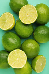 Green lime with cut in half on mint background. Vertical photo