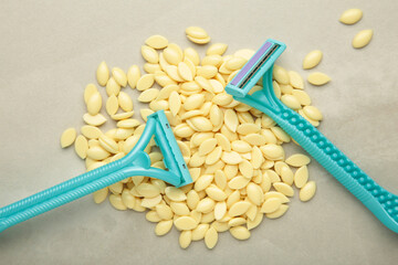 Wax granules for depilation with a razor on light background