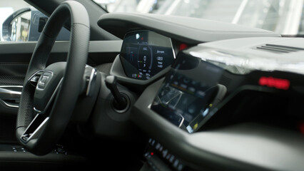 Obraz premium Close-up of a new electric car's interior, showcasing sleek design and cutting-edge technology. Perfect for highlighting modern automotive luxury and the future of eco-friendly transportation.