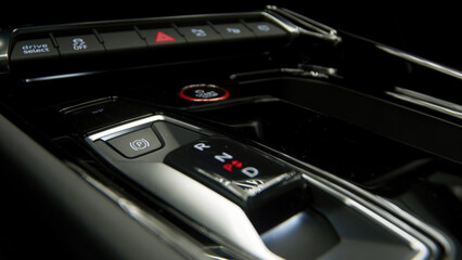 Fototapeta premium Close-up of the start button in a modern electric car, symbolizing innovation and the future of eco-friendly driving. Ideal for showcasing cutting-edge automotive technology and sustainable mobility.