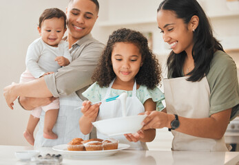 Baking, parents and children with cake decoration in kitchen for support, learning and teaching muffin recipe in home. Happy family, people and prepare dessert for cooking education, bonding or skill