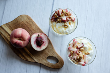 Greek yoghurt with peach and honey. Hight key. Place for text