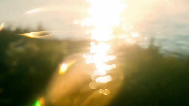 Blindingly bright lens flares illuminate the surface of the lake making it impossible to look away from the breathtaking view of the lakeside. Light leaks bokeh
