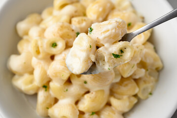Macaroni cheese in bowl with spoon, Close up, Top view