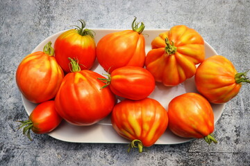 Fresh colorful ripe fall or summer heirloom pear tomatoes over table background. Harvest and cooking tomato sauce concept