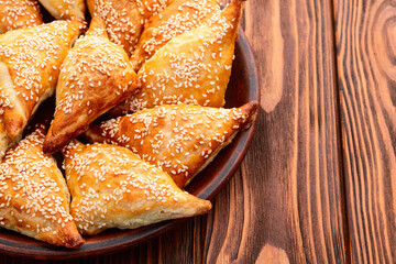 Homemade triangle puff pastry with meat on rustic background . Samosa