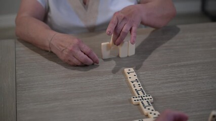 retired senior citizen couple play dominos - Powered by Adobe