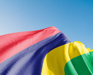Mauritius national flag cloth fabric waving on beautiful sky blue Background.