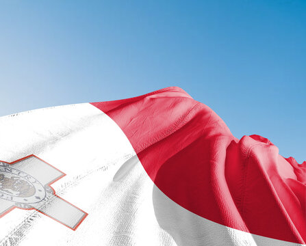 Malta national flag cloth fabric waving on beautiful sky blue Background.