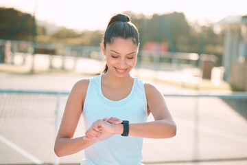 Woman, smart watch and tennis court with smile for sports, stats and thinking in summer with app...