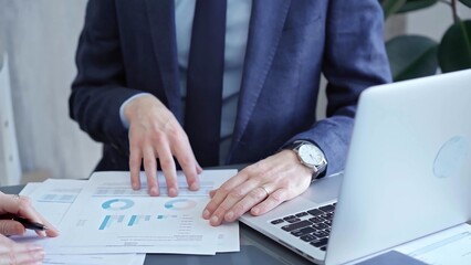 Two professionals analyzing a pie chart during a strategic business meeting. Business meeting with graph analysis