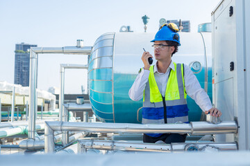 Engineer under industrial inspection Large water heaters are used in high-rise condominiums.