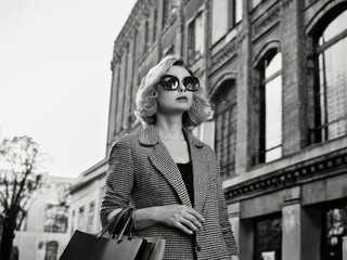 Fototapeta premium portrait of a woman with sunglasses coming from shopping
