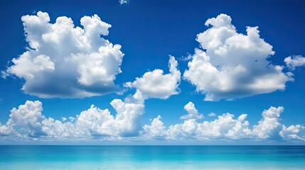 Abstract white clouds in a deep blue sky over a tropical beach. Perfect for a relaxing summer holiday.